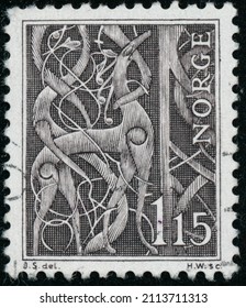 POLTAVA, UKRAINE - January 27, 2022. Vintage stamp printed in Norway circa 1969 shows detail from the North portal of the stave church of Urne