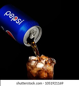 POLTAVA, UKRAINE - MARCH 22, 2018: Splash Pepsi Into A Glass On A Black Background. Pepsi Is A Carbonated Soft Drink Produced PepsiCo. Created In 1893