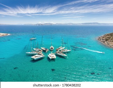 Polyaigos Island is a top Sailing destination in Cyclades Greece. Aerial View of private boats in star formation. Polyaegus, east of Milos and Kimolosl, largest uninhabited island. - Shutterstock ID 1780438202