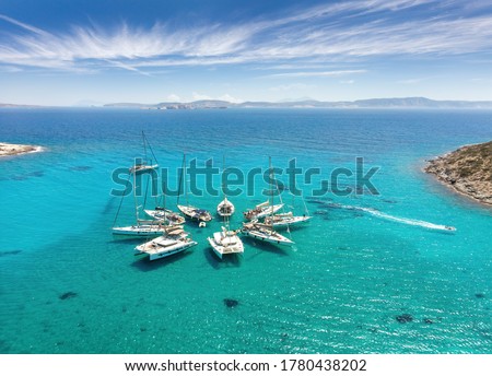 Polyaigos Island is a top Sailing destination in Cyclades Greece. Aerial View of private boats in star formation. Polyaegus, east of Milos and Kimolosl, largest uninhabited island. Foto d'archivio © 