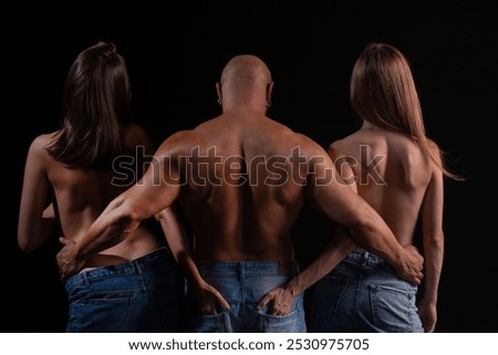 Polyamory and polygamy. Threesome of man and two sexy woman. Polyamory three people. Romantic relationships Polyamory of Threesome. A group of sexy models. Polyamory concept.