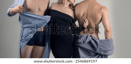 Polyamory and polygamy. Threesome of man and two sexy woman. Polyamory three people. Romantic relationships of Threesome. A group of sexy models. Man with two beautiful women fashion and beauty.
