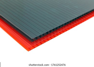 Polycarbonate Plastic Sheets Panels Images. PC Hollow Sheet For Translucent Roofing. Red And Green Color Sheets On White Background