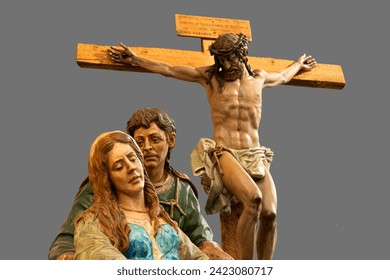 Polychrome wood carving of the crucifixion of Christ with Mary and Saint John at the foot of the cross. These wooden carvings go out in procession during Holy Week in Zamora, Spain.