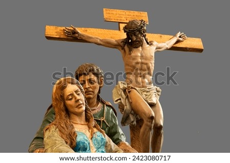 Polychrome wood carving of the crucifixion of Christ with Mary and Saint John at the foot of the cross. These wooden carvings go out in procession during Holy Week in Zamora, Spain.