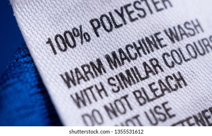 Polyester Clothing Label With Laundry Care Instructions Tag On Blue Shirt Jersey