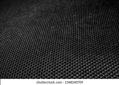 Polyester texture. Plexus black threads. Blurred background. Fabric.