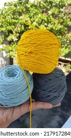 Polyester Yarn In Dark Gray, Yellow, Blue Colors.  Blurred Background.