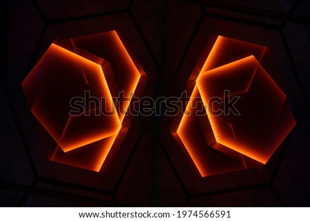 Polygonal lighting elements of suspended ceiling. Abstract architecture and modern interior background. Hexagonal lamps glowing in darkness. Minimal design. Decorative energy flow.