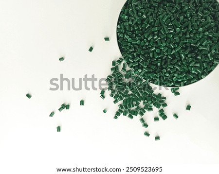 polymer granules. lucent green masterbatch cold cut type in laboratory pantry dish. isolated on white background. for industrial plastic product catalog design.