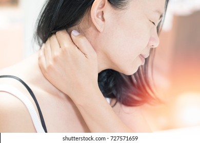 Polymyalgia, rheumatica neck pain disease concept. Asian female hand on her neck as suffering from office syndrome neck ache