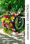 Polynesian cultural lei of beautiful colourful flowers at market stall on the tropical island of Mo