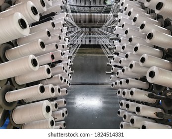 polypropylene plastic flat yarn bobbins loaded on circular loom weaving machine to produce woven fabric 