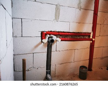 Polypropylene Plumbing Pipes In The Wall. New Construction Of The Bathroom, Installation Of Plastic Pipes With Insulation Inside The Wall