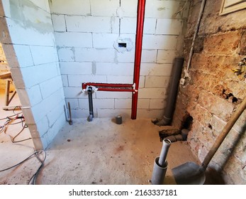 Polypropylene Plumbing Pipes In The Wall. New Construction Of The Bathroom, Installation Of Plastic Pipes With Insulation Inside The Wall