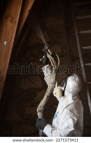 Polyurethane foam being applied on wall