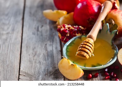 Pomegranate, apple and honey, traditional food of jewish New Year celebration, Rosh Hashana. Selective focus. Copyspace background - Powered by Shutterstock