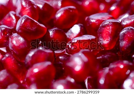 Pomegranate arils pattern. Pomegranate grains texture. Fresh pomegranate arils background. Pomegranate seeds macro texture.