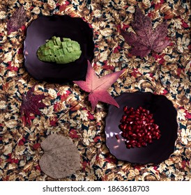 Pomegranate And Avocado On A Black Plate With Fall Leave Pattern