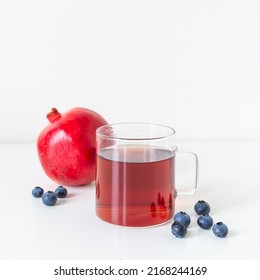 Pomegranate Blueberry Antioxidant Herbal Tea On White, Clear Glass Mug With Handle