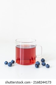 Pomegranate Blueberry Antioxidant Herbal Tea On White, Clear Glass Mug With Handle