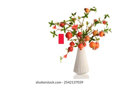 Pomegranate branch on white vase for display decoration on Vietnamese Tet Lunar New year. Ripe fruit Red Pomegranate blossom branches vintage vase Chinese new year concept - Powered by Shutterstock