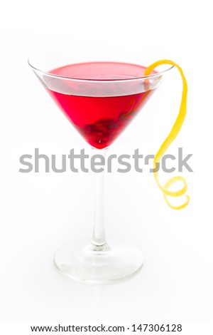 Pomegranate cosmo cocktail with lemon as a garnish.