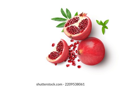 Pomegranate Fruit With Green Leaves And Half Sliced With Seeds Isolated On White Background. Top View. Flat Lay.