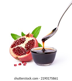 Pomegranate Fruit With Pomegranate Molasses In Glass Bowl With Spoon Isolated On White Background.