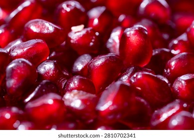 Pomegranate grains texture. Macro of pomegranate arils. Pomegranate arils pattern. Red ruby pomegranate arils closeup pattern.