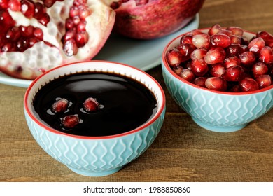 Pomegranate Molasses In Small Bowl. Pomegranate Sweet And Sour Syrup With Pomegranate Fruit And Seeds.