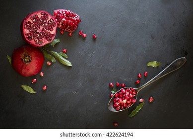 Pomegranate On Black Textured Background. Overhead Text View Image.