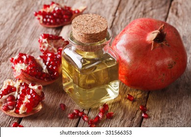 Pomegranate seed oil in a glass bottle on a table close-up. Horizontal