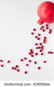 pomegranate and seeds on white background