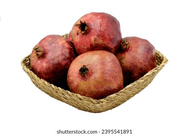 Pomes of pomegranates (Punica granatum) in a basket