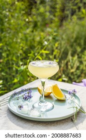 Pompadour Glass Of Lavender Lemonade With Cube Ice With Lavender Flowers. Table In Summer Garden.