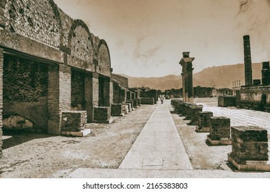 POMPEI, ITALY - JUNE 28, 2021: Tourists Visit Famous Ruins Of Ancient City Of Pompei Near Volcano Vesuvio.