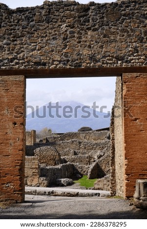 Pompeii, Italy. View of Vesuvius through an portal at the Triangular Forum.