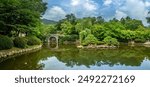 Pond and bridge surrounded by weeping willows in the gardens of the Bulguksa temple, Tohamsan, Gyeongju, South Korea.