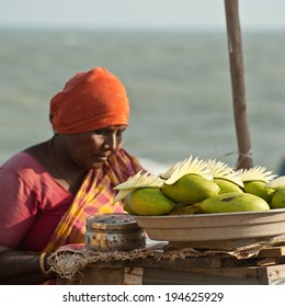 PONDICHERRY, INDIA - FEBRUARY 12: Indian Woman Selling Mango Fruits At Market On February 12, 2013 In Pondicherry, India. Lot Of Vegetables And Fruits Important Ingredients Of Traditional Indian Food