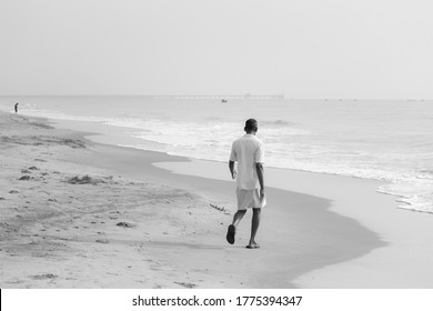 PONDICHERRY, INDIA - July 17: The Old Man Wearing Dhoti, Waking On The Sea Shore And Moving Forward Towards The Road 17, 2020 In Pondicherry, India.