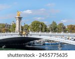 Pont Alexandre III bridge Beaux Arts style, crosses the Seine river on its way through Paris and connects the esplanade of Des Invalides and the Grand Palais and the Petit Palais.
