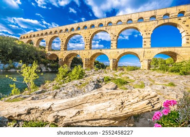 The Pont du Gard ancient Roman aqueduct bridge built in the first century AD to carry water to Nîmes. It crosses the river Gardon near the town of Vers-Pont-du-Gard in southern France. - Powered by Shutterstock