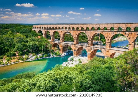 Pont du Gard, France. Ancient three-tiered aqueduct, built in Roman Empire times on the river Gardon. Provence, tourist destination, summer sunny day landscape.