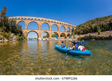 Pont Du Gard With Paddle Boats Is An Old Roman Aqueduct In Provence, France