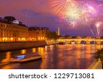 Pont Neuf and Cite island over Seine river with Paris cityscape and fireworks at night, France