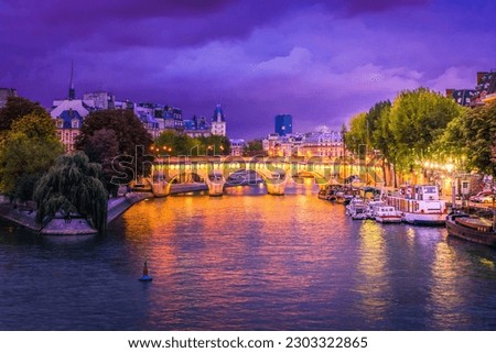 Pont Neuf and river Seine waters at blue night, Paris, France