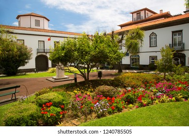Ponta Delgada city center with public flower gardens in the parks and squares  of courtyards between the houses - Shutterstock ID 1240785505