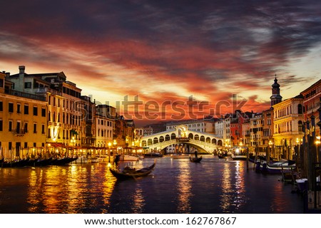 Ponte Rialto and gondola at sunset in Venice, Italy