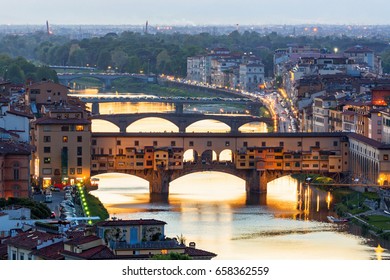 Ponte Vecchio Bridge Over The Arno River In Florence With Floodlight